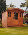 Stamford summer house with glazed double doors and side windows in a landscaped garden by IN Sheds
