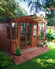 Kelmarsh summer house with verandah and Georgian windows in a landscaped garden by IN Sheds