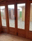 Interior view of Elkington summer house showing glazed doors and windows with natural light