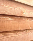 Close-up of overlap weatherboard timber cladding on garden shed