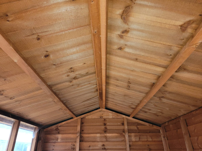 Interior roof construction of weatherboard apex shed showing solid timber framework